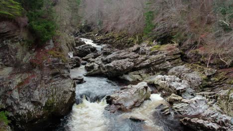 aerial-view-of-wilderness-waterfall-stream-of-clear-water-in-Findhorn-village-in-Moray,-Scotland