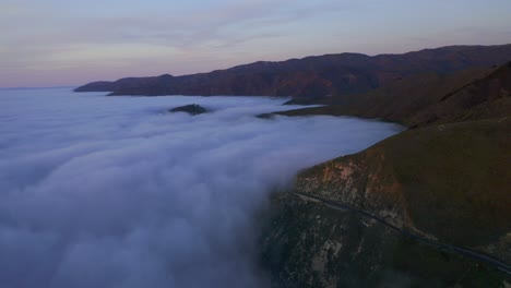 Drone-Shots-of-Pacific-Coast-Cliffs-near-Big-Sur-and-Carmel-Highlands-California-during-Marine-Fog-Layer-and-Sunset