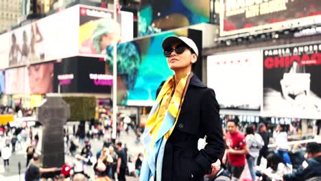 Asian-woman-looking-around-and-taking-in-the-many-sights-and-sounds-at-Time-Square-in-New-York-City
