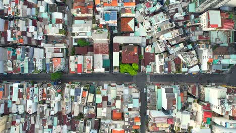 aerial-top-down-shot-of-a-perpendicular-road-intersection-in-a-densely-populated-asian-city-in-the-afternoon-as-motorbikes-drive-through-the-narrow-roads-in-Ho-Chi-Minh-City-Vietnam