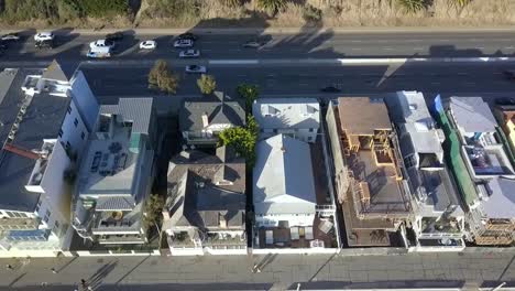Expensive-beach-houses,-villas-on-Pacific-hwy-one-Calmer-aerial-view-flight-drone-camera-pointing-down-footage-at-LA-Santa-Monica-Pier-California-USA-2018-Cinematic-view-from-above-by-Philipp-Marnitz