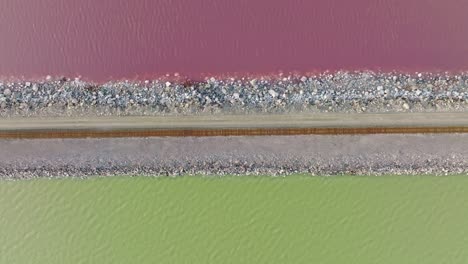 AERIAL---Railway,-Lucin-Cutoff,-purple-green-Great-Salt-Lake,-Utah,-top-down-right-to-left
