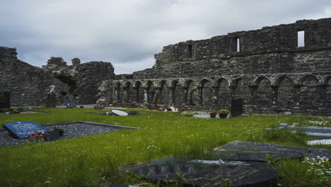 Motion-time-lapse-of-Creevelea-Abbey-medieval-ruin-in-county-Leitrim-in-Ireland-as-a-historical-sightseeing-landmark-and-graveyard-with-dramatic-clouds-in-the-sky-on-a-summer-day