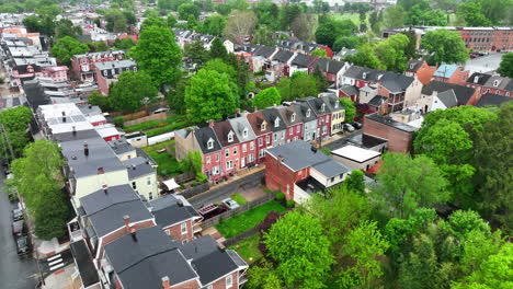 Aerial-reverse-rising-shot-of-tightly-packed-homes-in-city