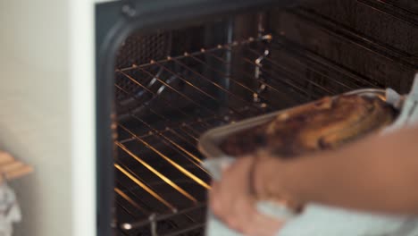 Slow-motion-Close-up-shot-of-a-woman-taking-the-cake-out-of-a-white-hot-oven