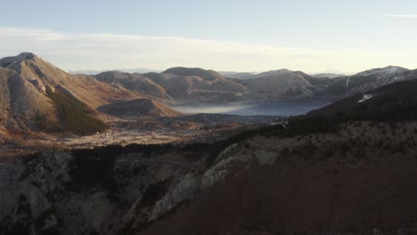 Aerial-drone-view-above-mountainous-Kotor-Bay-at-sunrise-in-bright-morning