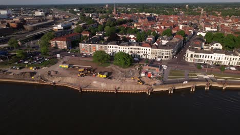 Aerial-approach-showing-quay-under-construction-seen-from-above-river-IJssel-with-work-in-progress-on-the-IJsselkade-boulevard-of-tower-town-Zutphen