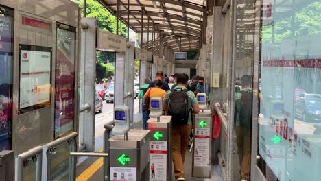 People-Swiping-Through-Automatic-Ticket-Barrier-To-Get-On-Mexico-City-Metrobus