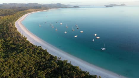 Whitehaven-Beach-Whitsundays-aerial-tracking-backwards-with-boats,-Queensland