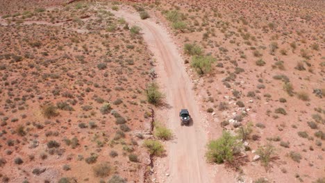 Overhead-aerial-following-a-dune-buggy-in-the-desert