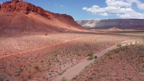 Aerial-of-a-dune-buggy-riding-through-desert-terrain