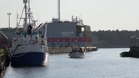 Ship-Sails-Slowly-in-Klaipeda-near-Maxine-Douglas-Cargo-Ship-on-a-Sunny-Evening