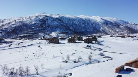 Sideways-moving-aerial-overview-of-lodging-apartments-with-ski-in-at-Hardangervidda-mountain---Maurset
