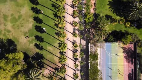 Overhead-view-over-Ines-de-Suarez-Park-with-people-walking-and-trees-in-the-background