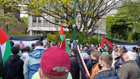 Truck-shot,-walking-past-a-Palestinean-protest-in-Dublin-with-people-holding-flags