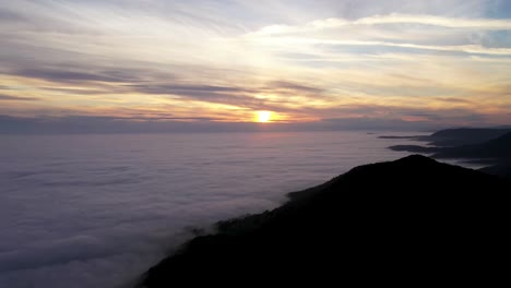 Aerial-View-Of-Beautiful-Sunset-Over-Sea-of-Clouds
