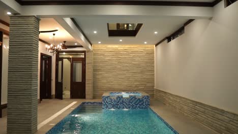 View-Of-Indoor-Swimming-Pool-In-Luxury-Home-With-Blue-White-Tiling