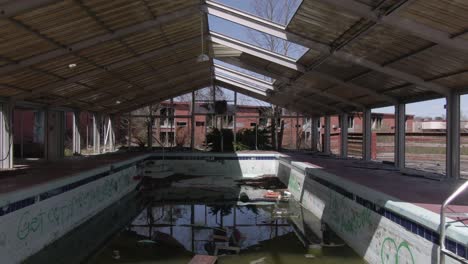 Aerial-Drone-Footage-Dollying-Backwards-Over-an-Abandoned-Covered-Pool