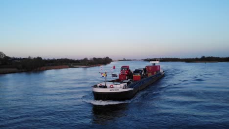 Cargo-Ship-With-Trucks-And-Intermodal-Containers-Sailing-At-Oude-Maas-River-In-Netherlands