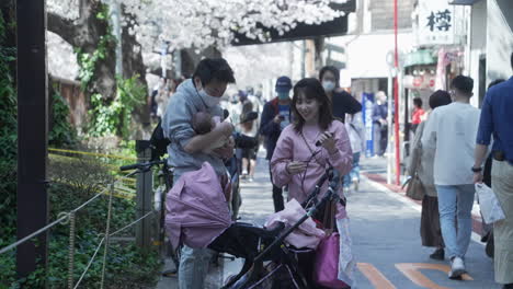 Young-Married-Couple-With-Their-Baby-During-Hanami-Amidst-Corona-Virus-In-Tokyo,-Japan