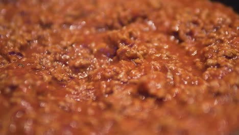 close-up-of-cooking-sauce-bolognese-with-minced-meat-boiling-in-pan