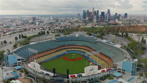 Approaching-aerial-view-of-Downtown-Los-Angeles-and-Dodgers-Stadium