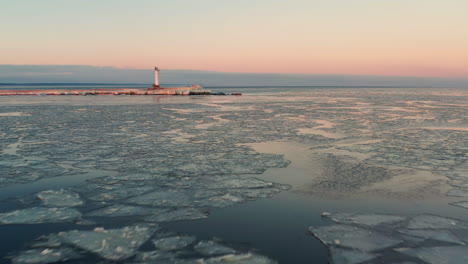 Frozen-Baltic-sea-coastline,-sunset-aerial-view-over-Gulf-of-Riga
