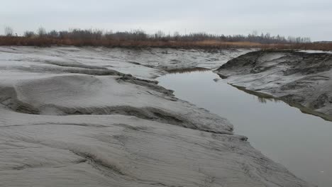 Dry-land-on-river-banks-during-low-tide-flood-in-aerial-truck-shot