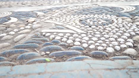 Intricate-luxury-pebble-stone-mosaic-story-images-flooring-sophisticated-abstract-art-flooring-closeup-dolly-left