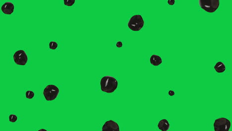 Ein-Kleiner-Haufen-Glänzender-Brauner-Tapioka-Kugeln,-Die-Vor-Einem-Grünen-Bildschirm-Schweben