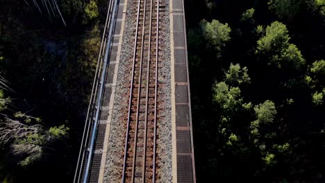 Railroad-tracks-on-high-train-trestle-bridge