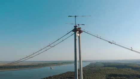 Podul-Brăila---suspension-bridge-in-Romania,-under-construction-over-the-Danube-river---aerial-drone-shot