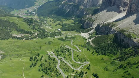 Aerial-of-cars-driving-on-scenic-zigzag-mountain-road,-Dolomites-italy