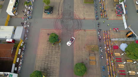 Aerial-View-Of-A-White-Sports-Car-Drifting-At-The-Arena-During-Stunt-Show