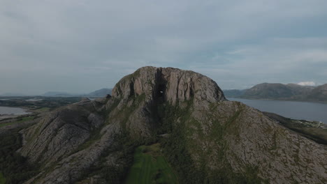 Aerial-View-Of-The-Mountain-Torghatten-In-Brønnøysund,-Northern-Norway---drone-pullback