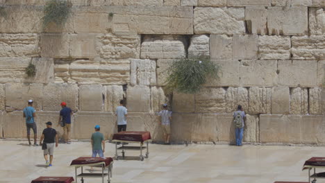People-praying-at-the-Western-Wall-or-Wailing-Wall,-Jerusalem,-Israel,-wide-shot