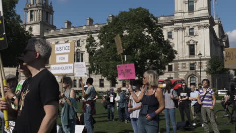 People-Holding-Up-Placards-In-Parliament-Square-For-Leaseholders-Together-Rally
