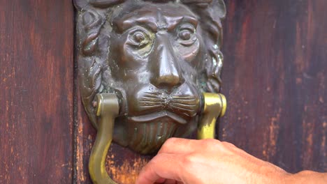 Hand-grabbing-door-knocker.-Colonial-lion-door-knocker