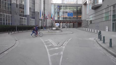 People-Walk-Near-The-Entrance-Of-European-Parliament-Building-In-Brussels,-Belgium