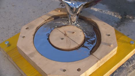 Pouring-liquid-metal-lead-in-wooden-mold