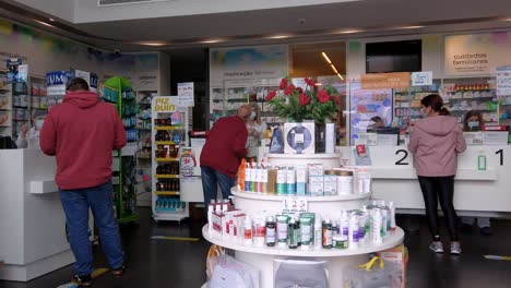 Back-view-of-people-with-protective-mask-in-local-pharmacy