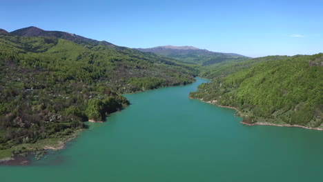 Beautiful-blue-green-river-of-the-Maneciu-Dam-in-Romania--Aerial-panning