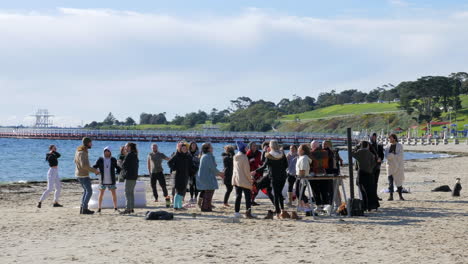 SLOW-MOTION,-Crowd-Of-Dancers-Party-On-Sandy-Beach-On-Cold-Winters-Day