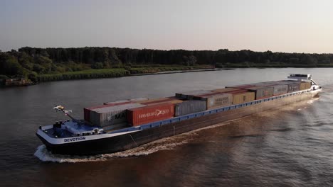 Aerial-View-Of-Cargo-Ship-Devotion-Going-Past-On-Oude-Maas-Near-Barendrecht
