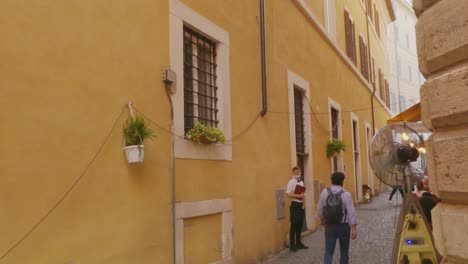First-person-pov-of-Via-della-Guglia-and-tourists-in-Rome-center