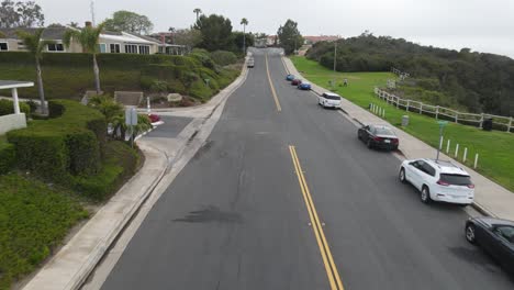 Aerial-view-of-a-car-driving,-on-the-streets-of-Los-Angeles---reverse,-drone-shot