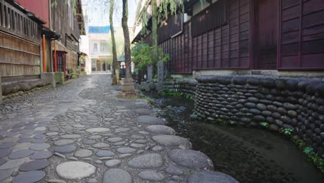 Stream-Running-Through-Gujo-Hachiman-Town-Streets,-Gifu,-Japan