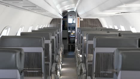 Empty-Seats-in-Airplane-Flying,-Dolly-Forward