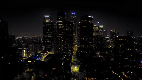 Aerial-shot-of-Downtown-Los-Angeles-at-night-with-skyscrapers-on-the-skyline