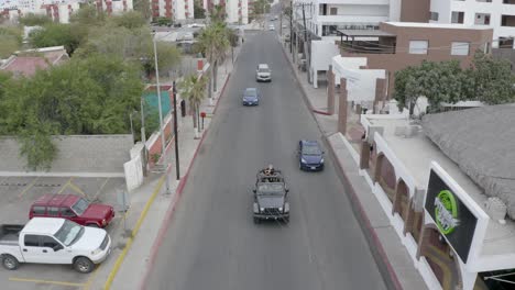 Ground-of-friends-on-a-sport-utility-vehicles,-streets-of-El-Medano,-Cabo-San-Lucas,Mexico